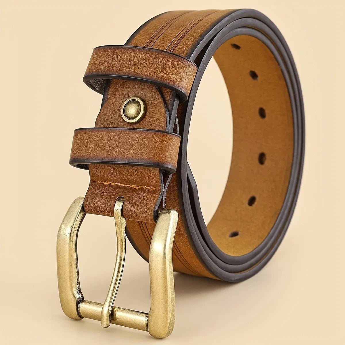Sierra Oro tooled Western belt in brown and tan laid flat, showing embossed edge tooling and brass gold tone roller buckle